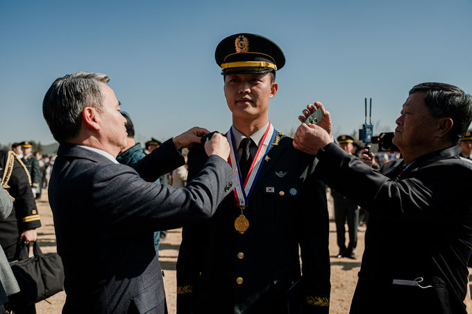 육군3사관학교에서 27일 실시된 제58기 졸업 및 임관식에서 국방부장관과 신임장교 가족이 신임 장교에게 계급장을 수여하고 있다