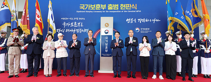 한덕수 국무총리(왼쪽 여섯번째)가 5일 오전 정부세종청사에서 열린 국가보훈부 출범 현판식에서 박민식 보훈부 장관(왼쪽 일곱번째) 등 참석자들과 현판 제막을 마친 뒤 기념 촬영을 하며 박수치고 있다.