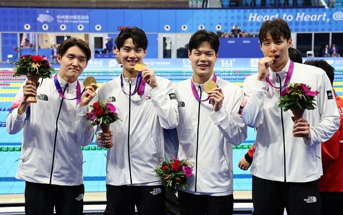 양재훈, 이호준, 김우민, 황선우가 9월 25일 중국 항저우 올림픽 스포츠센터 수영장에서 열린 2022 항저우 아시안게임 수영 남자 800m 계영 결승 시상식에서 금메달을 획득한 뒤 환호하고 있다.(사진=연합뉴스)