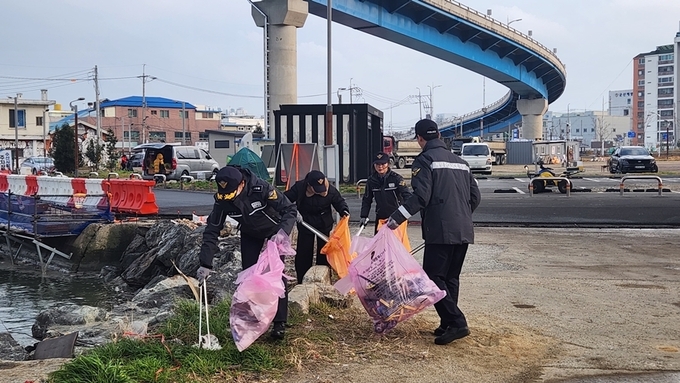군산해경 해양안전과 직원들이 해망동 일원에서 정화 활동을 펼치고 있다