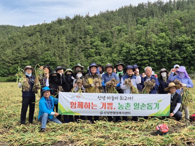 최기문 영천시장을 비롯한 영천시 신녕면 직원들이 마늘 수확 일손 돕기 후 단체 사진을 찍고 있다.