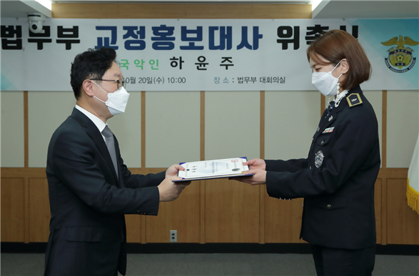박범계 장관이 국악인 하윤주씨에게 교정홍보대사 위촉장을 전달하고 있다.